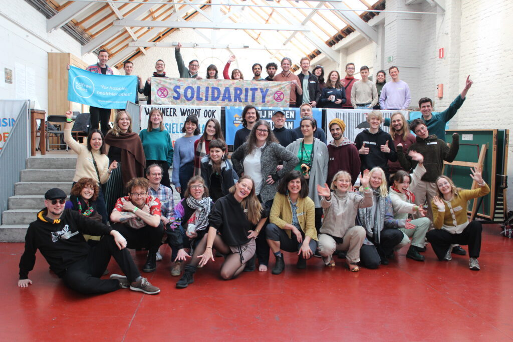 Group photo during the Ban Fossil Ads conference in Brussels in March 2024, Dr. Leah Temper in front row centre with yellow sweater.